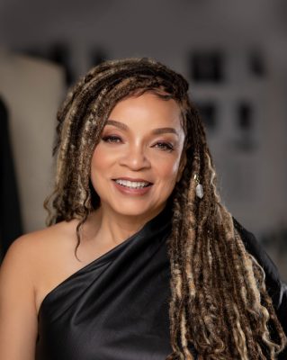 A headshot of Academy Award winning costume designer Ruth E. Carter in a black one-shouldered satin evening gown. She will be speaking at Moss Arts Center January 19, 2023 at 6pm. 